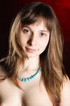 European teen Jenny D slips off blue jeans for nude posing on her bed