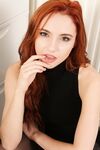 Model with red wavy hair Sophia Blake undresses & poses in sheer tights