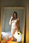 Sexy brunette Scarlot Rose lets a nipple slip while changing her underthings