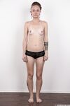 Pierced and tattooed amateur Petra stands naked after removing her clothes