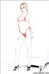 Blonde MILF in thong bikini showing off her big jugs and shaved slit
