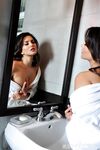 Hot brunette chick Sunny Leone reveals nice tits and landing strip pussy
