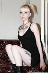 Alternative babe Symone posing for non nude pics in boots and black dress