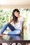 Brunette amateur Ana Greco slips off ripped jeans to get nude on a patio table