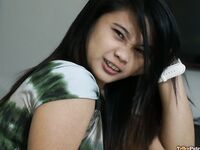 Cute Filipina teen gives a blowjob attired in a Santa Clause cap
