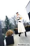 Classy blonde flashes the village below on her patio in latex attire