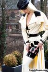 Classy blonde flashes the village below on her patio in latex attire