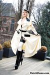 Classy blonde flashes the village below on her patio in latex attire
