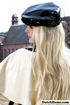 Classy blonde flashes the village below on her patio in latex attire