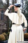 Classy blonde flashes the village below on her patio in latex attire