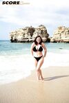 Brunette MILF Lorna Morgan releases her nice melons from bikini on a beach