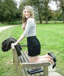 Leg model poses on a country bench in black skirt and pumps