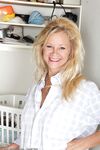 Busty blonde mature Heidi Gallo spreading ass naked in the laundry room