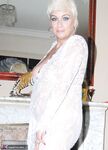 Older woman Dimonty pulls her tits out of long lace dress wearing no panties