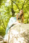 Teen princess in long dress Milena D teases with her hairy pussy in the woods