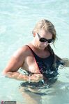 Blonde amateur SweetSusi pulls her tits out form her swimsuit in the pool