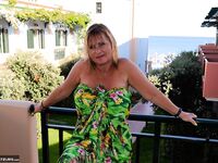 Slutty mature nudist with large tits Chrissy shows her hot curves at the beach