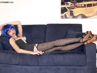 Blue haired alt babe Thena striking sexy poses in black nylons and garters