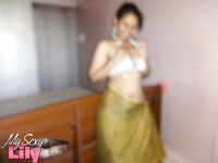 Indian woman lets a boob slip loose from her bra while being a tease
