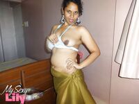 Indian woman lets a boob slip loose from her bra while being a tease