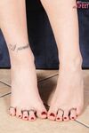 Clothed woman sniffs her flat shoes before showing her pretty feet