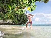 Horny blonde Bernice in bikini masturbating wet twat with dildo on beach