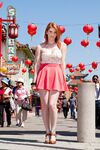 Stunning redhead Lilith Lust flashes her panties in daring Chinatown upskirt