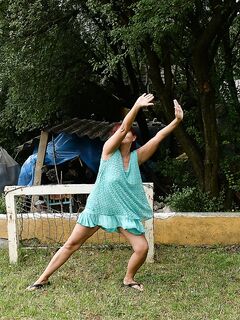 Redhead granny Livia lifts her blue dress up and reveals big natural tits