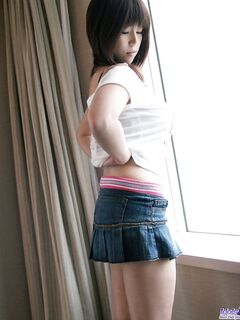 Japanese teen Haduki uncovers her great tits and hairy bush as she disrobes