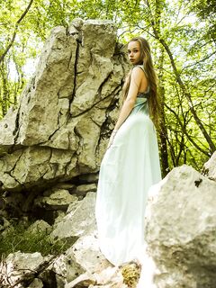 Teen princess in long dress Milena D teases with her hairy pussy in the woods