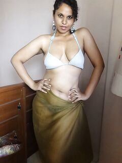 Indian woman lets a boob slip loose from her bra while being a tease