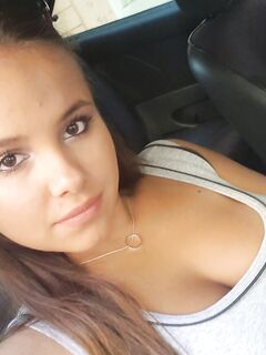 Young looking Latina girl Olivia hides her huge tits while taking selfies